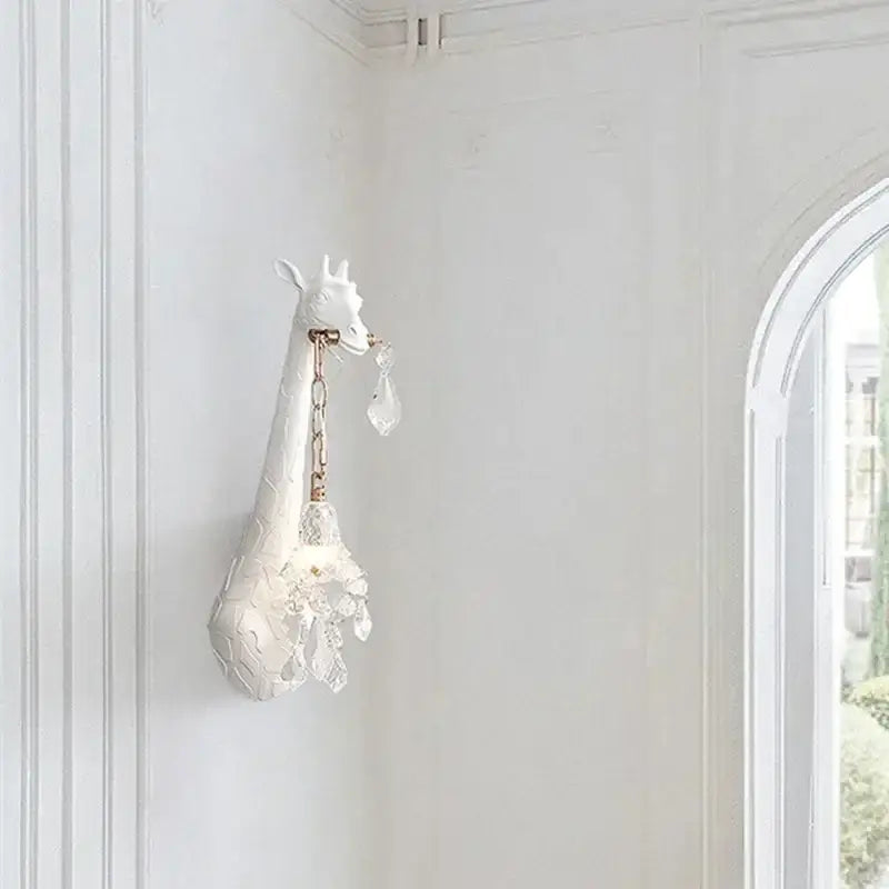 White ceramic giraffe love wall lamp with crystal accents and gold chain for bedside room decor by DecorBites™