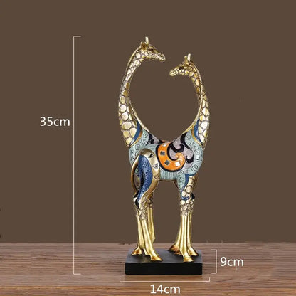 Decorbites giraffe mother and child painted sculpture with gold-toned bodies and intricate blue orange black designs on black base