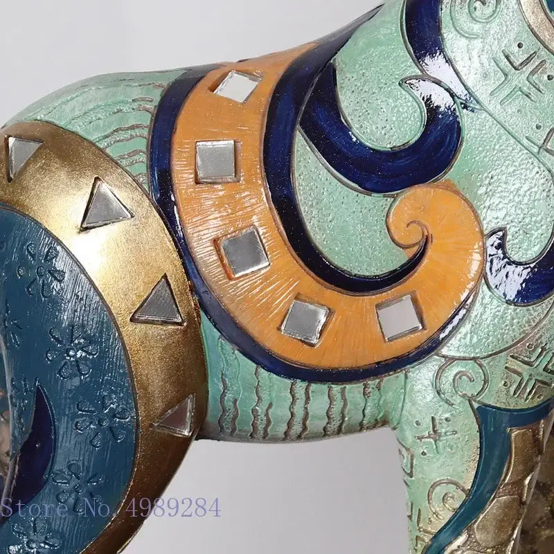 A decorative ceramic elephant figurine with turquoise gold and orange patterns and mirrored squares for modern decorbites giraffe mother and child painted sculpture