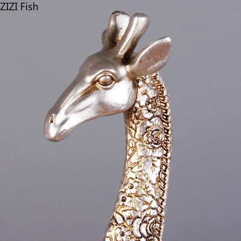 Silver and gold-toned giraffe resin statue ornament with intricate floral embossing for desk decoration by DecorBites™