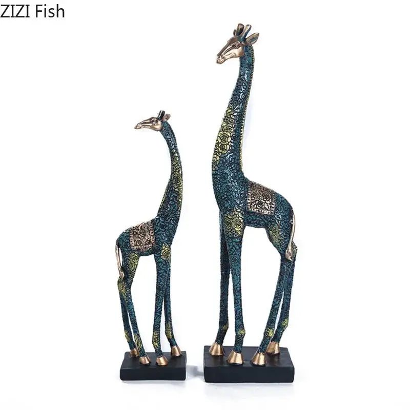 Two ornate dark teal and gold giraffe resin statues with patterned finish ideal as resin statue ornaments for decor