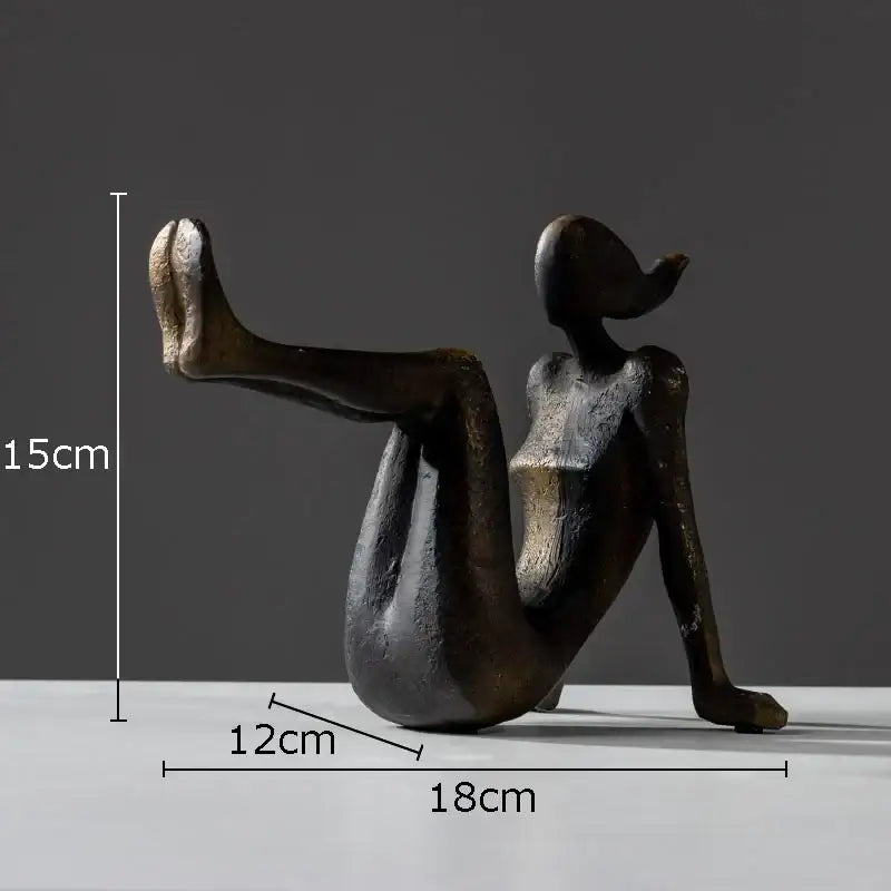 Bronze-colored resin decorbites girl statue bookends featuring a seated woman with one leg extended upward for desk decor