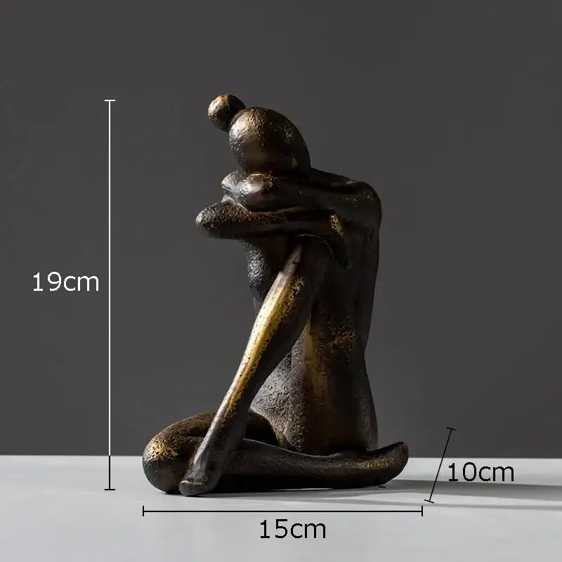 Bronze-colored decorbites girl statue bookends featuring a textured seated hugging figure with gold accents in resin
