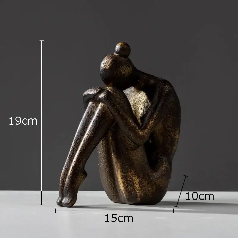 Bronze-colored abstract resin decorbites girl statue with textured surface seated human form for bookends decor