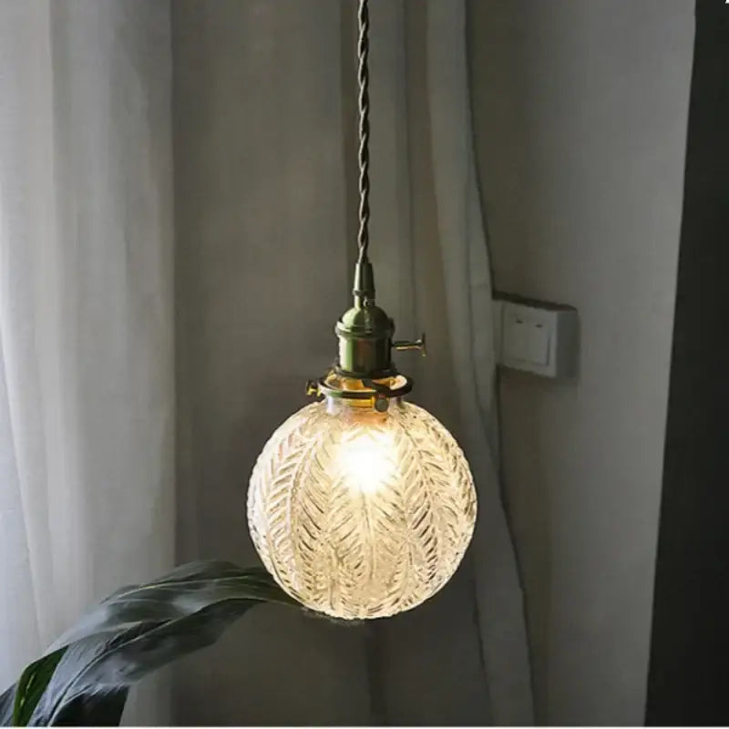 DecorBites Glabe glass LED pendant light fixture with warm textured glass and brass hardware for bedroom and kitchen