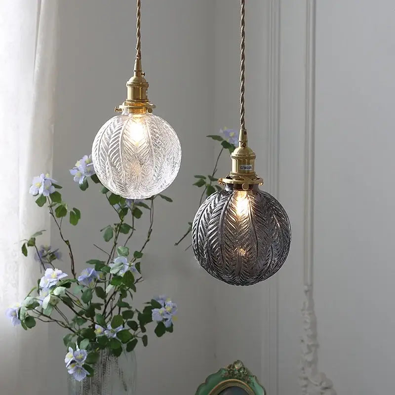Decorbites™ glabe glass pendant light fixture with clear and smoky gray etched glass suspended by twisted brass cords