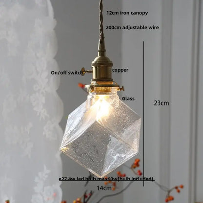 A warm-glowing DecorBites Glabe LED pendant lamp with faceted glass, brass copper fixture, and adjustable iron canopy