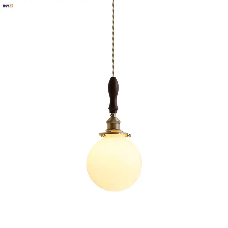 Warm-toned spherical glass pendant lamp with dark walnut wood handle and brass accents decorbites glabe led pendant