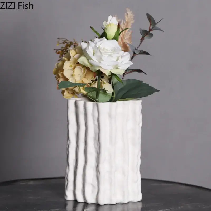White ceramic vaso with vertical ribbed texture holding artificial flowers in decorbites glacial ceramic vase design