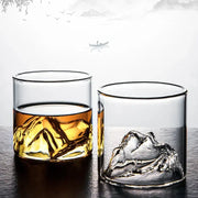 Clear glass DecorBites Glacier wine cup with sculpted mountain base filled with amber whisky and ice
