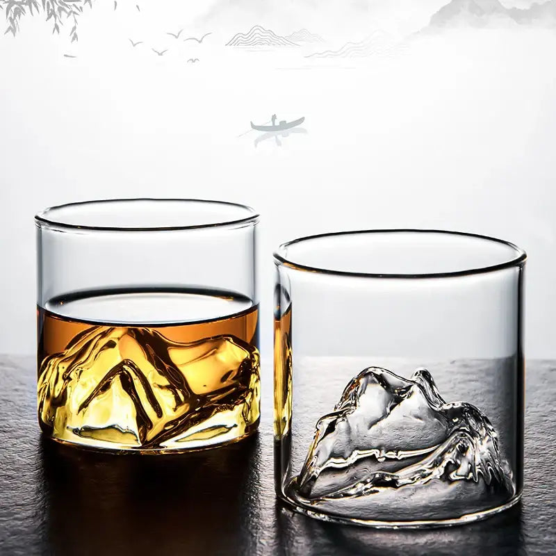 Clear glass DecorBites Glacier wine cup with sculpted mountain base filled with amber whisky and ice