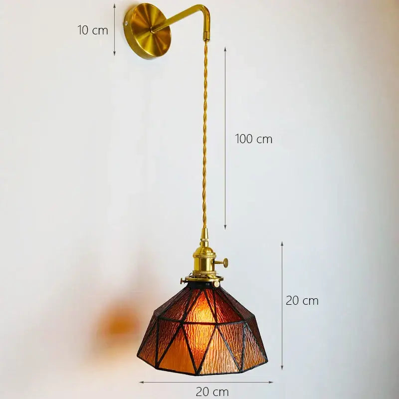 A vintage-style brass DecorBites glass adjustable wall light with amber geometric stained glass shade for bedroom decor