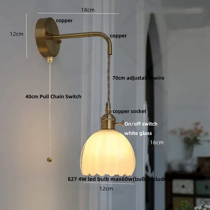 Antique brass-finished DecorBites glass adjustable wall lamp with scalloped white glass shade and copper wire arm