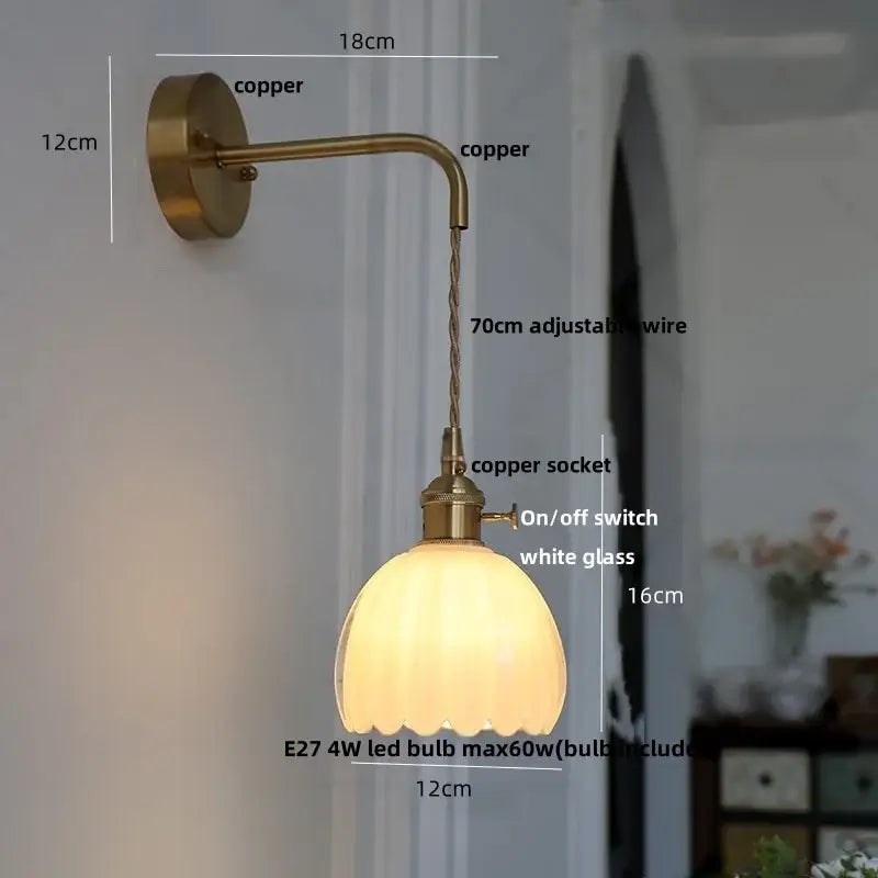 A warm-toned copper decorbites glass adjustable led wall lamp with scalloped white glass shade and 70cm wire