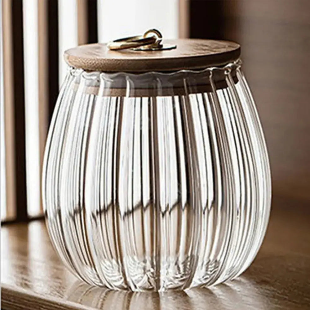 Clear decorbites glass airtight canister with vertical ridges and wooden lid featuring brass ring handle for kitchen storage