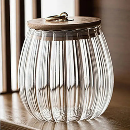 Clear decorbites glass airtight canister with vertical ridges and wooden lid featuring brass ring handle for kitchen storage