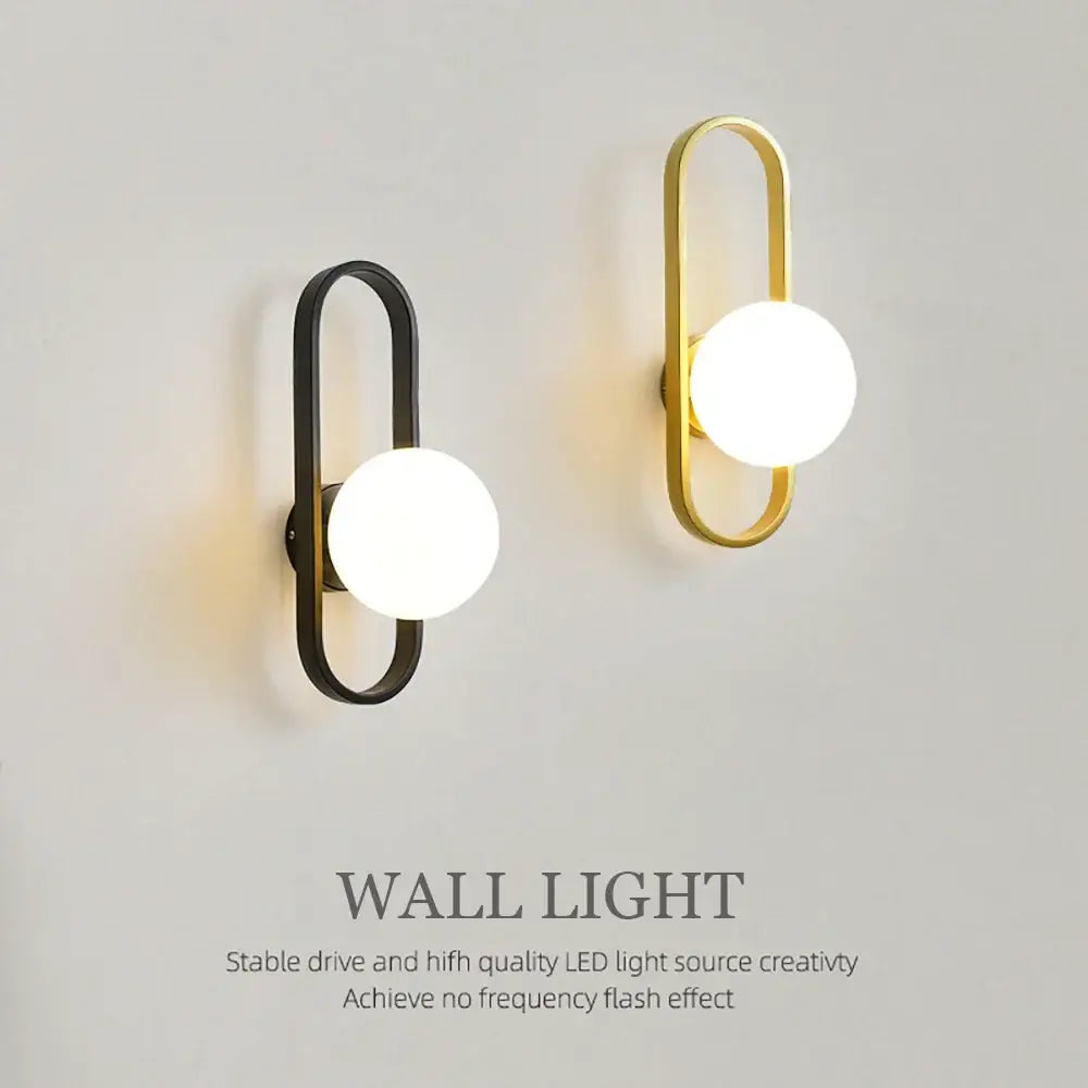 Modern minimalist wall lamp with black and gold metal frame and frosted glass globe from decorbites glass aisle wall collection