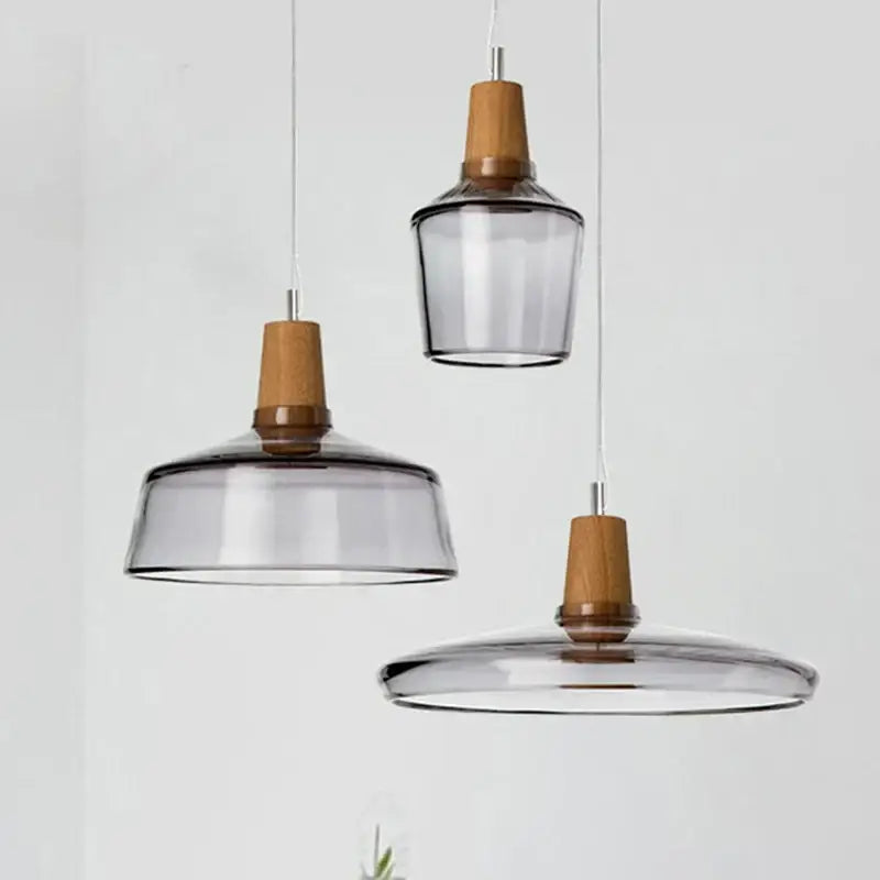 Set of three modern pendant lights with smoked glass shades and natural wood accents decorbites glass wood pendant light