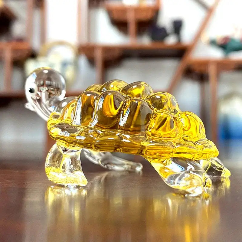 A translucent yellow glass animal figurine turtle with clear head and limbs from DecorBites™ hand blown art collectibles