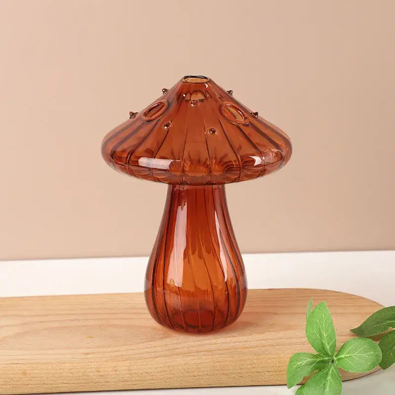 Amber-colored glass aromatherapy vase in a mushroom shape with ribbed texture and circular details for home decor