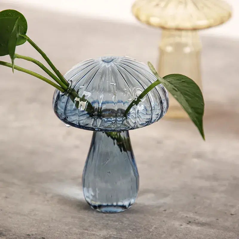 DecorBites™ translucent blue glass aromatherapy vase with ribbed mushroom shape holds green stems for home decor