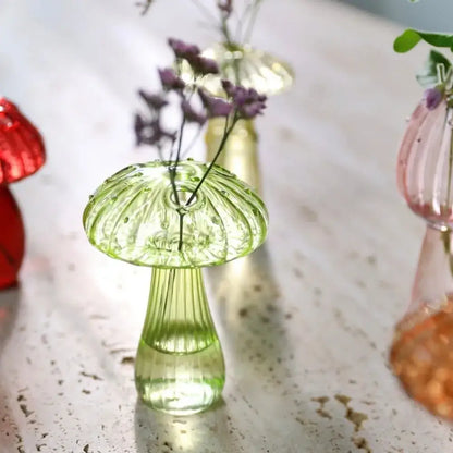DecorBites™ translucent green glass aromatherapy vase shaped like a mushroom with purple flowers for home decor