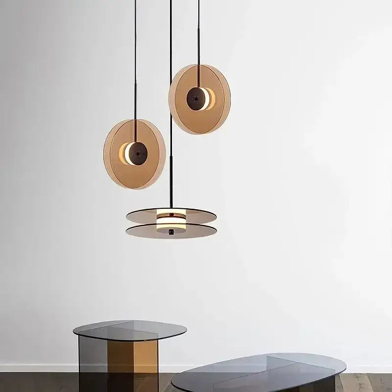 Modern gold-toned circular decorbites glass art chandelier with sleek black cords minimalist design for home and cafe lighting