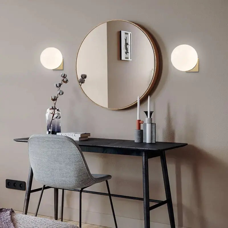 Round wooden-framed mirror with minimalist design and reflective surface complementing decorbites glass ball wall lamp