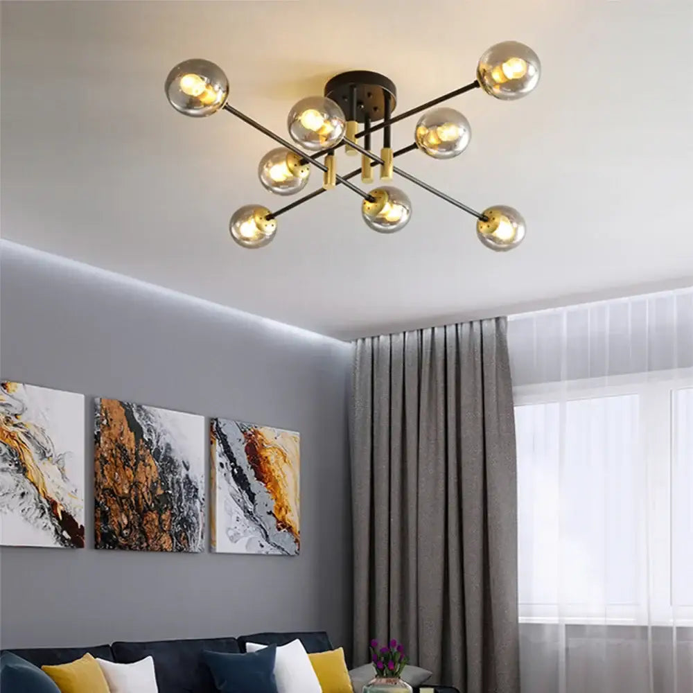 Modern decorbites glass ball black chandelier with gold accents and spherical glass bulbs for dining table lighting