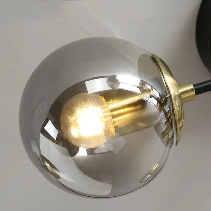 A decorbites glass ball black spherical pendant light with brushed brass fixture and exposed edison bulb for dining ceilings