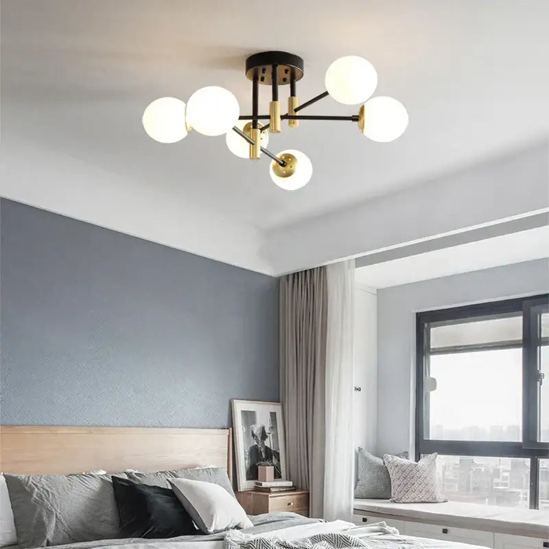 Modern black and gold ceiling light with spherical white glass bulbs from decorbites glass ball black chandelier collection