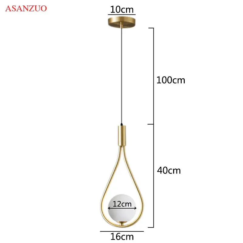 Gold-toned glass ball brass pendant light with teardrop shape and white bulb by DecorBites for nordic bedroom decor