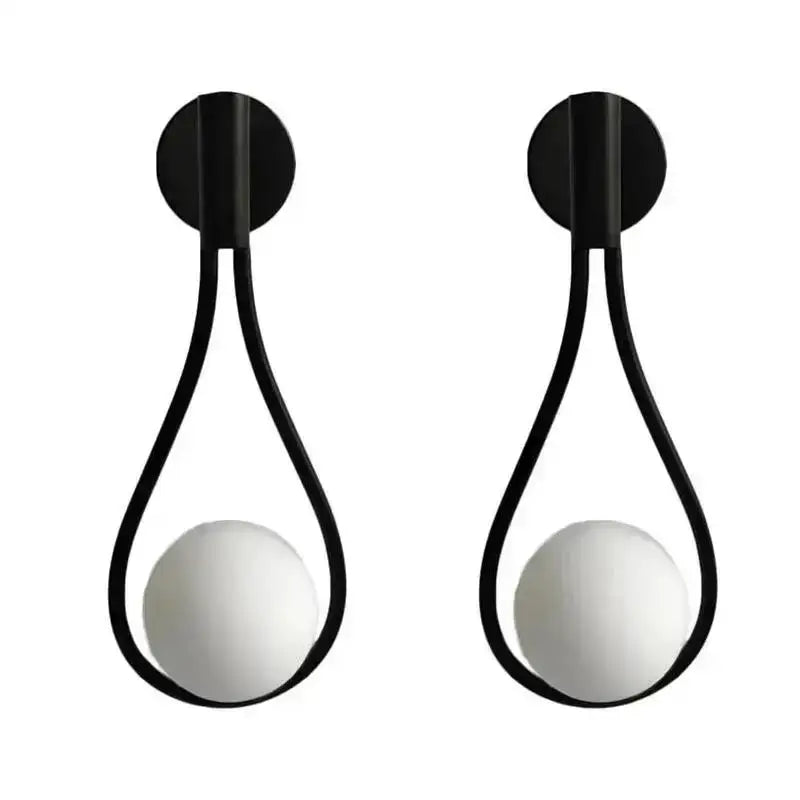 Decorbites glass ball wall lamp featuring black teardrop metal frame and white spherical glass globes for bedroom lighting
