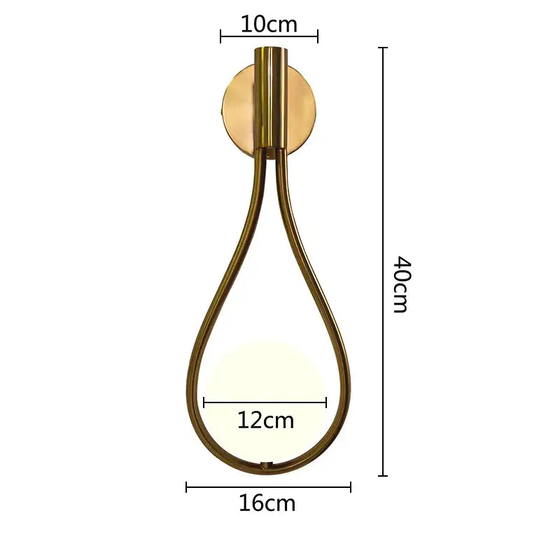 A sleek brass teardrop wall lamp with warm glowing light by decorbites glass ball brass for bedroom and living room lighting
