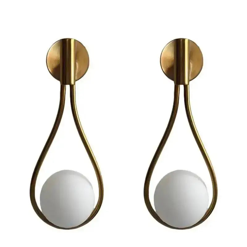 Pair of brass teardrop wall lamp sconces with white glass ball shades from DecorBites glass ball brass collection