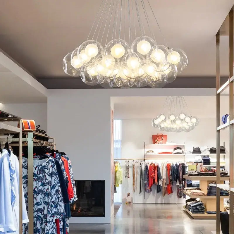 Modern glass globe bubble chandelier with illuminated spheres suspended on thin wires for living room by DecorBites