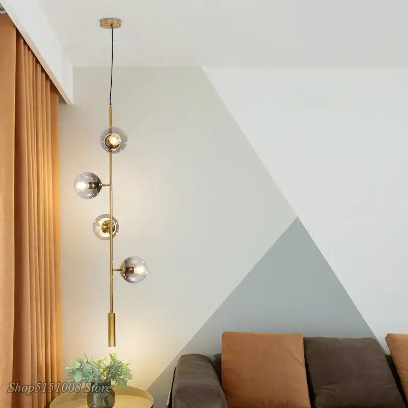 Modern gold-toned decorbites glass ball pendant light with four spherical glass ball bubble led shades hanging vertically