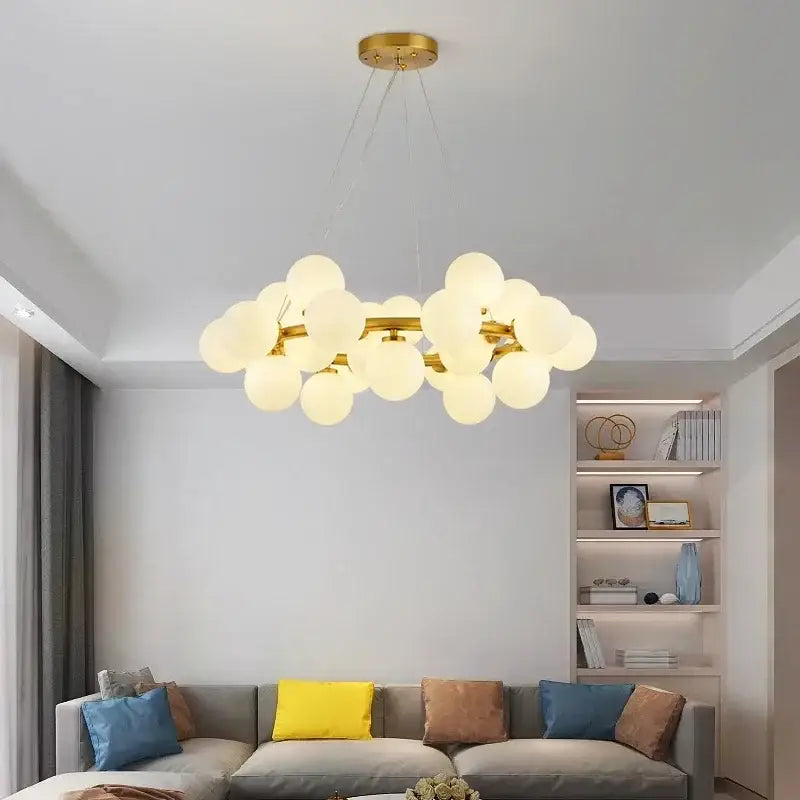 Gold-toned DecorBites glass ball ceiling chandelier with frosted glass globe bulbs for dining and living room decor