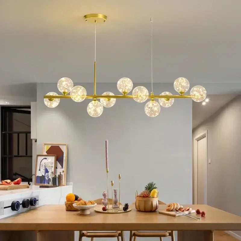 Gold-toned DecorBites™ glass ball ceiling chandelier with frosted glass globe bulbs in a modern linear design