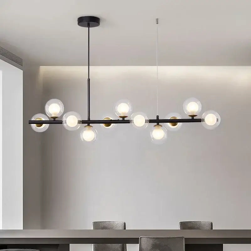 Modern black metal DecorBites™ ball ceiling chandelier with clear glass globe bulbs and gold-toned accents for home lighting