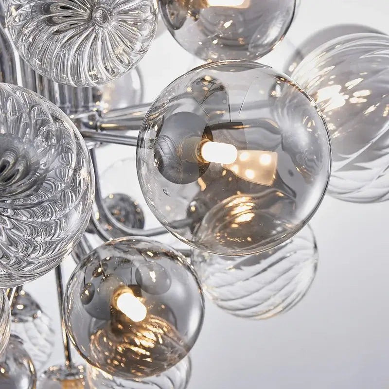 A decorbites glass ball ceiling chandelier with clear textured glass spheres and a chrome frame for living spaces