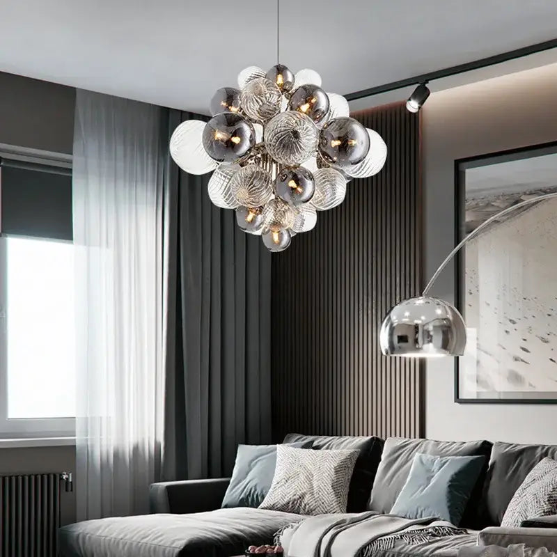 A modern decorbites glass ball ceiling chandelier with reflective silver and clear glass bulbs for living room use