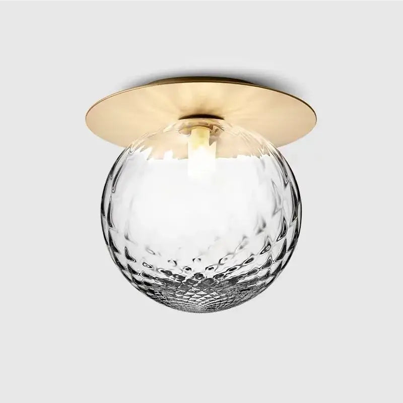 Aisel home ceiling light with decorbites glass ball featuring a hammered clear glass globe and polished brass base