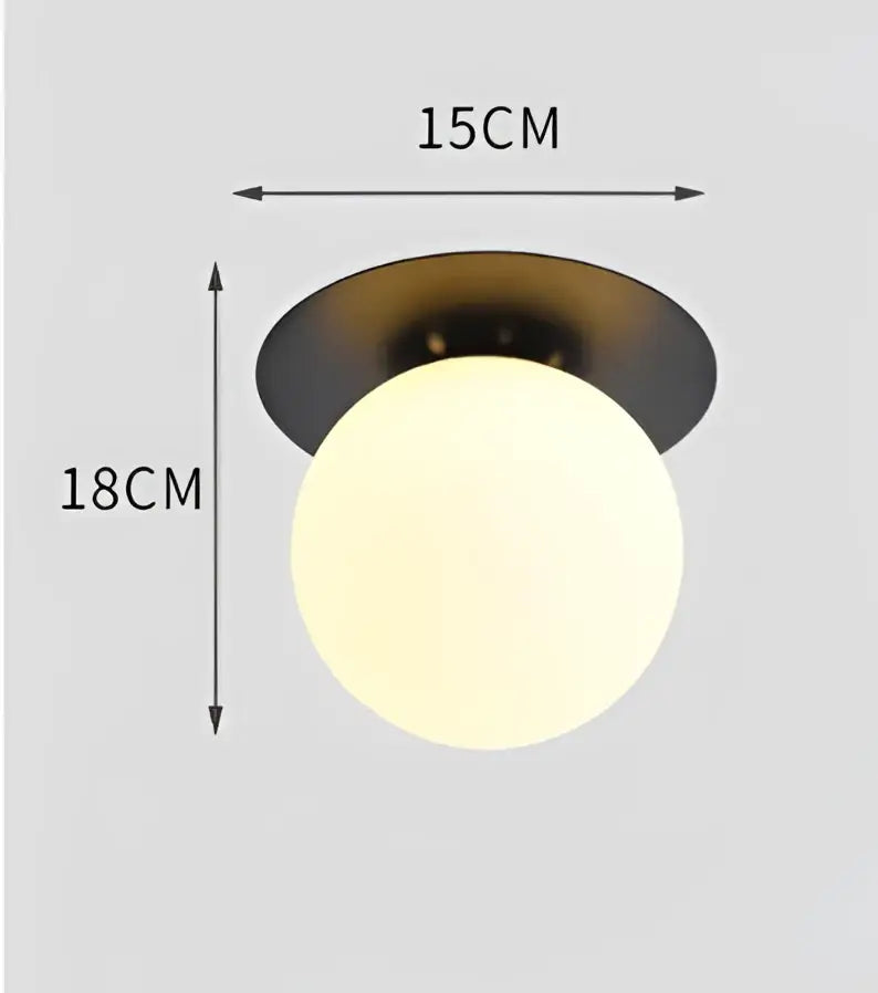 A decorbites glass ball ceiling light with a matte black base and frosted white glass globe for modern interiors