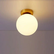 Decorbites glass ball ceiling light fixture with a warm glowing glass globe and brass-finished mounting base for bedrooms