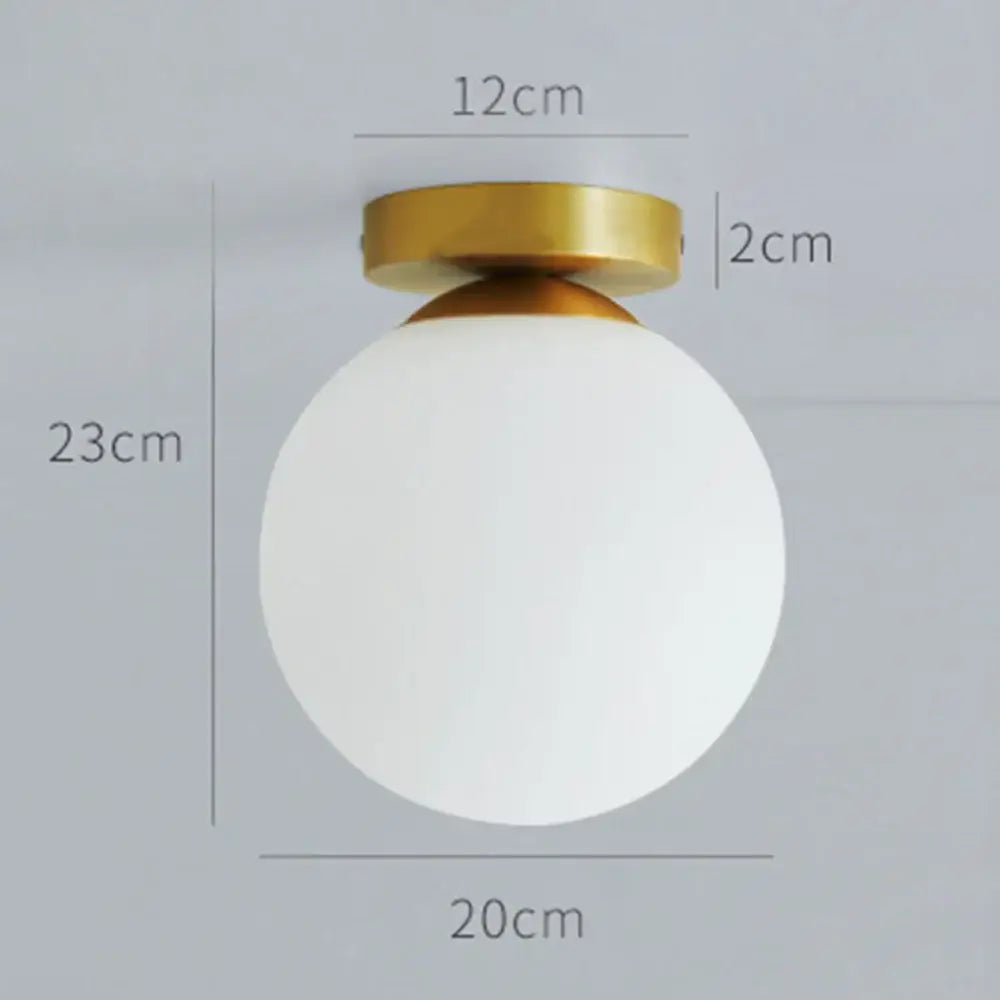 A sleek decorbites glass ball ceiling light with frosted white glass globe and polished gold metal fixture for modern decor