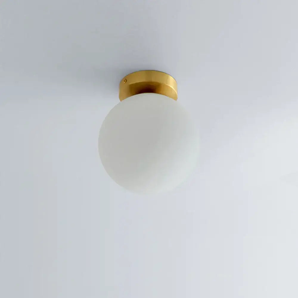 DecorBites glass ball ceiling light fixture with frosted glass globe and polished brass base for modern bedroom decor