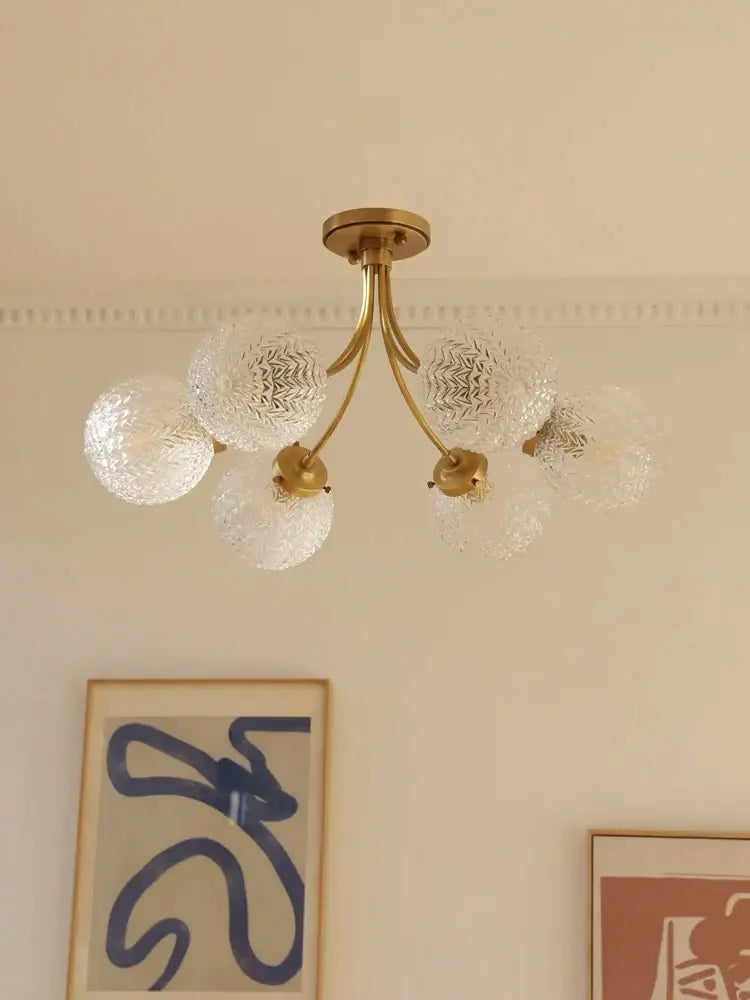 Brass-finished decorbites glass ball ceiling light with five clear textured glass globe shades for modern interiors