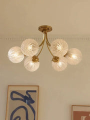 Brass-finished decorbites glass ball ceiling light with five textured frosted glass globe shades for modern interiors