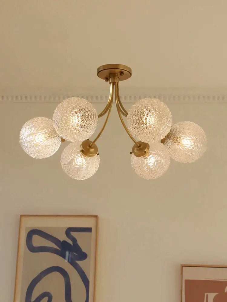 Brass-finished decorbites glass ball ceiling light with five textured frosted glass globe shades for modern interiors